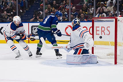 Oct 11, 2023; Vancouver, British Columbia, CAN; Edmonton Oilers defenseman Brett Kulak (27) watches as Vancouver Canucks forward Conor Garland (8) scores on goalie Jack Campbell (36) in the first period at Rogers Arena. Mandatory Credit: Bob Frid-USA TODAY Sports