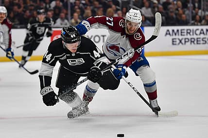 Oct 11, 2023; Los Angeles, California, USA; Colorado Avalanche left wing Jonathan Drouin (27) plays for the puck against Los Angeles Kings defenseman Mikey Anderson (44) during the first period at Crypto.com Arena. Mandatory Credit: Gary A. Vasquez-USA TODAY Sports