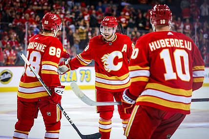 Oct 11, 2023; Calgary, Alberta, CAN; Calgary Flames center Elias Lindholm (28) celebrates his goal with teammates against the Winnipeg Jets during the third period at Scotiabank Saddledome. Mandatory Credit: Sergei Belski-USA TODAY Sports