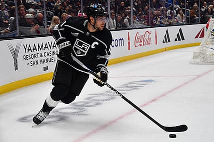 Oct 11, 2023; Los Angeles, California, USA; Los Angeles Kings center Anze Kopitar (11) moves the puck against the Colorado Avalanche during the second period at Crypto.com Arena. Mandatory Credit: Gary A. Vasquez-USA TODAY Sports