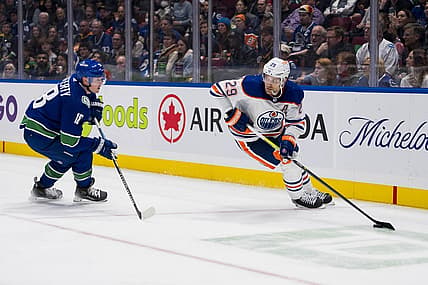 Oct 11, 2023; Vancouver, British Columbia, CAN; Vancouver Canucks forward Sam Lafferty (18) skates after Edmonton Oilers forward Leon Draisaitl (29)in the second period at Rogers Arena. Mandatory Credit: Bob Frid-USA TODAY Sports