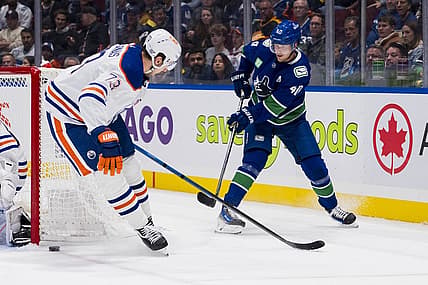Oct 11, 2023; Vancouver, British Columbia, CAN; Vancouver Canucks forward Elias Pettersson (40) passes the puck behind Edmonton Oilers defenseman Vincent Desharnais (73) in the first period at Rogers Arena. Mandatory Credit: Bob Frid-USA TODAY Sports