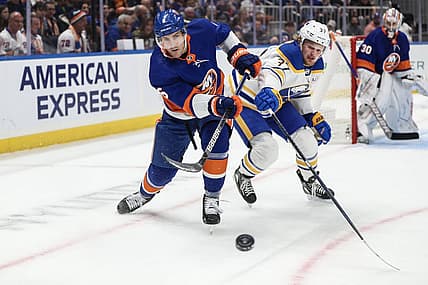 Oct 14, 2023; Elmont, New York, USA;  New York Islanders defenseman Ryan Pulock (6) and Buffalo Sabres center Casey Mittelstadt (37) battle for control of the puck in the first period at UBS Arena. Mandatory Credit: Wendell Cruz-USA TODAY Sports