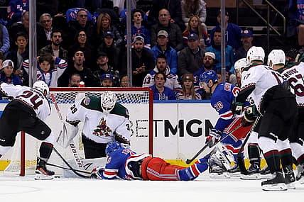 Oct 16, 2023; New York, New York, USA; New York Rangers center Vincent Trocheck (16) lunges for the puck in front of Arizona Coyotes goaltender Connor Ingram (39) during the first period at Madison Square Garden. Mandatory Credit: Brad Penner-USA TODAY Sports