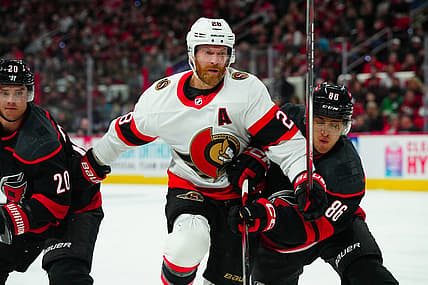Oct 11, 2023; Raleigh, North Carolina, USA;  Ottawa Senators right wing Claude Giroux (28) and Carolina Hurricanes left wing Teuvo Teravainen (86) battle for position during the second period at PNC Arena. Mandatory Credit: James Guillory-USA TODAY Sports