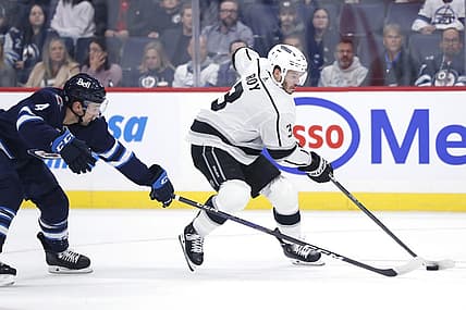 Oct 17, 2023; Winnipeg, Manitoba, CAN; Winnipeg Jets defenseman Neal Pionk (4) checks Los Angeles Kings defenseman Matt Roy (3) in the first period at Canada Life Centre. Mandatory Credit: James Carey Lauder-USA TODAY Sports
