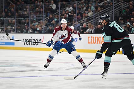 Oct 17, 2023; Seattle, Washington, USA; Colorado Avalanche center Ryan Johansen (12) defends Seattle Kraken defenseman Brian Dumoulin (8) during the first period at Climate Pledge Arena. Mandatory Credit: Steven Bisig-USA TODAY Sports