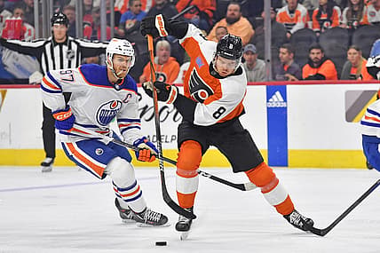 Oct 19, 2023; Philadelphia, Pennsylvania, USA; Philadelphia Flyers defenseman Cam York (8) skates with puck against Edmonton Oilers center Connor McDavid (97) during the first period at Wells Fargo Center. Mandatory Credit: Eric Hartline-USA TODAY Sports