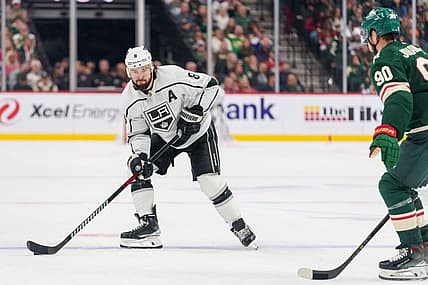 Oct 19, 2023; Saint Paul, Minnesota, USA; Los Angeles Kings defenseman Drew Doughty (8) sets up on the blue line defended by Minnesota Wild left wing Marcus Johansson (90) in the second period at Xcel Energy Center. Mandatory Credit: Matt Blewett-USA TODAY Sports