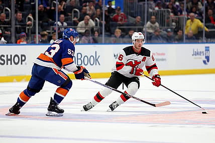 Oct 20, 2023; Elmont, New York, USA; New Jersey Devils center Jack Hughes (86) skates with the puck against New York Islanders center Casey Cizikas (53) during the first period at UBS Arena. Mandatory Credit: Brad Penner-USA TODAY Sports