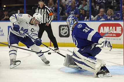 Oct 21, 2023; Tampa, Florida, USA;  Toronto Maple Leafs center John Tavares (91) shoots the puck on Tampa Bay Lightning goaltender Jonas Johansson (31) in overtime at Amalie Arena. Mandatory Credit: Nathan Ray Seebeck-USA TODAY Sports