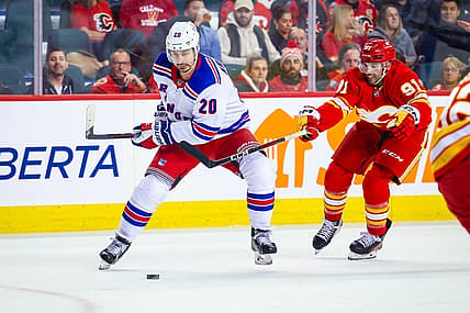 Oct 24, 2023; Calgary, Alberta, CAN; New York Rangers left wing Chris Kreider (20) controls the puck in front of Calgary Flames center Nazem Kadri (91) during the first period at Scotiabank Saddledome. Mandatory Credit: Sergei Belski-USA TODAY Sports