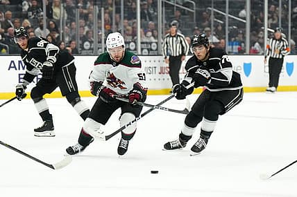 Oct 24, 2023; Los Angeles, California, USA; Arizona Coyotes left wing Michael Carcone (53) and LA Kings right wing Alex Laferriere (78) battle for the puck in the first period at Crypto.com Arena. Mandatory Credit: Kirby Lee-USA TODAY Sports
