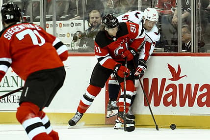 Oct 25, 2023; Newark, New Jersey, USA; New Jersey Devils center Dawson Mercer (91) checks Washington Capitals left wing Beck Malenstyn (47) during the first period at Prudential Center. Mandatory Credit: John Jones-USA TODAY Sports