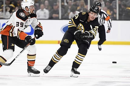 Oct 26, 2023; Boston, Massachusetts, USA; Boston Bruins defenseman Jesper Boqvist (70) shoots the puck while Anaheim Ducks center Sam Carrick (39) defends during the first period at TD Garden. Mandatory Credit: Bob DeChiara-USA TODAY Sports
