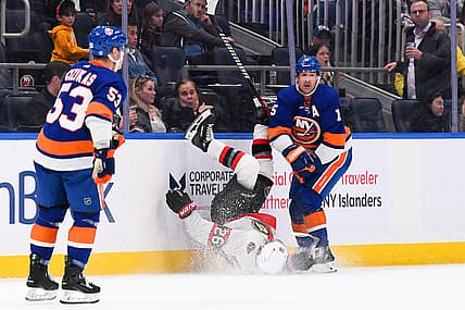 Oct 26, 2023; Elmont, New York, USA; New York Islanders right wing Cal Clutterbuck (15) checks Ottawa Senators defenseman Erik Brannstrom (26) into the boards during the second period at UBS Arena. Mandatory Credit: Dennis Schneidler-USA TODAY Sports