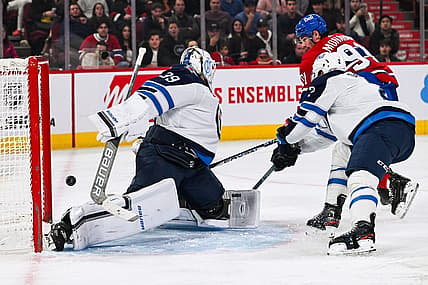 Oct 28, 2023; Montreal, Quebec, CAN; Winnipeg Jets goalie Laurent Brossoit (39) gives a goal to Montreal Canadiens center Sean Monahan (91) during the second period at Bell Centre. Mandatory Credit: David Kirouac-USA TODAY Sports