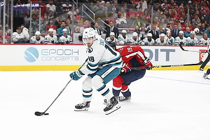 Oct 29, 2023; Washington, District of Columbia, USA; San Jose Sharks right wing Filip Zadina (18) controls the puck in front of Washington Capitals center Nicklas Backstrom (19) during the first period at Capital One Arena. Mandatory Credit: Amber Searls-USA TODAY Sports