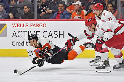 Oct 30, 2023; Philadelphia, Pennsylvania, USA; Philadelphia Flyers right wing Tyson Foerster (71) passes the puck while being untended by Carolina Hurricanes right wing Jesper Fast (71) and defenseman Dmitry Orlov (7) during the first period at Wells Fargo Center. Mandatory Credit: Eric Hartline-USA TODAY Sports