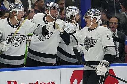Oct 31, 2023; Toronto, Ontario, CAN; Los Angeles  Kings defenseman Andreas Englund (5) gets congratulated after scoring against the Toronto Maple Leafs during the first period at Scotiabank Arena. Mandatory Credit: John E. Sokolowski-USA TODAY Sports