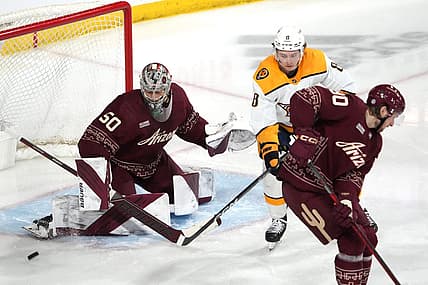 Mar 9, 2023; Tempe, Arizona, USA; Arizona Coyotes Ivan Prosvetov (50) makes a save in front of Nashville Predators center Cody Glass (8) during the third period at Mullett Arena. Mandatory Credit: Joe Camporeale-USA TODAY Sports