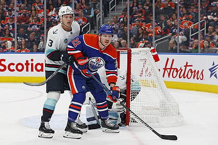 Oct 6, 2023; Edmonton, Alberta, CAN; Edmonton Oilers forward Adam Erne (21) battles for position with Seattle Kraken defensemen Will Borgen (3) in front of goaltender Philipp Grubauer (31) during the first period at Rogers Place. Mandatory Credit: Perry Nelson-USA TODAY Sports