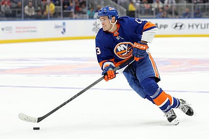 Oct 20, 2023; Elmont, New York, USA; New York Islanders center Mathew Barzal (13) skates with the puck against the New Jersey Devils during overtime at UBS Arena. Mandatory Credit: Brad Penner-USA TODAY Sports