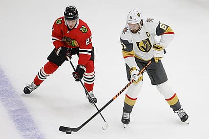 Oct 21, 2023; Chicago, Illinois, USA; Chicago Blackhawks left wing Lukas Reichel (27) battles for the puck with Vegas Golden Knights right wing Mark Stone (61) during the first period at United Center. Mandatory Credit: Kamil Krzaczynski-USA TODAY Sports