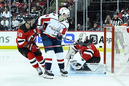 Oct 25, 2023; Newark, New Jersey, USA; Washington Capitals center Connor McMichael (24) scores a goal against New Jersey Devils goaltender Vitek Vanecek (41) during the third period at Prudential Center. Mandatory Credit: John Jones-USA TODAY Sports