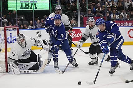 Oct 31, 2023; Toronto, Ontario, CAN; Toronto Maple Leafs forward Mitchell Marner (16) tries to get on shot off at Los Angeles Kings goaltender Cam Talbot (39) as Toronto Maple Leafs forward Auston Matthews (34) and Los Angeles Kings defenseman Vladislav Gavrikov (84) look on during the third period at Scotiabank Arena. Mandatory Credit: John E. Sokolowski-USA TODAY Sports
