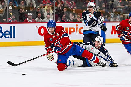 Oct 28, 2023; Montreal, Quebec, CAN; Montreal Canadiens center Nick Suzuki (14) and Winnipeg Jets defenseman Josh Morrissey (44) during the second period at Bell Centre. Mandatory Credit: David Kirouac-USA TODAY Sports