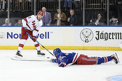 Nov 2, 2023; New York, New York, USA; New York Rangers defenseman K'Andre Miller (79) tries to deflect a pass attempt by Carolina Hurricanes center Jesperi Kotkaniemi (82) in the first period at Madison Square Garden. Mandatory Credit: Wendell Cruz-USA TODAY Sports