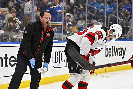 Nov 3, 2023; St. Louis, Missouri, USA;  New Jersey Devils center Jack Hughes (86) is checked on by a trainer after slamming in to the boards during the first period against the St. Louis Blues at Enterprise Center. Mandatory Credit: Jeff Curry-USA TODAY Sports