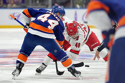 Nov 4, 2023; Elmont, New York, USA; New York Islanders center Jean-Gabriel Pageau (44) and Carolina Hurricanes left wing Jordan Martinook (48) take a face-off during the first period at UBS Arena. Mandatory Credit: Brad Penner-USA TODAY Sports