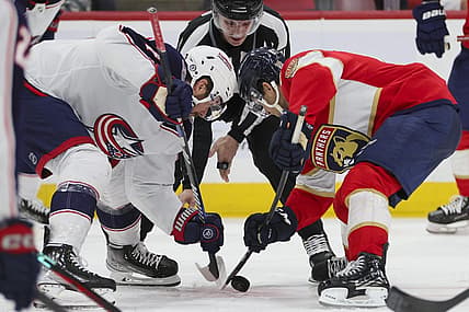 Nov 6, 2023; Sunrise, Florida, USA; Columbus Blue Jackets center Sean Kuraly (7) and Florida Panthers right wing William Lockwood (67) face-off during the second period at Amerant Bank Arena. Mandatory Credit: Sam Navarro-USA TODAY Sports