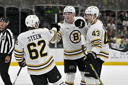 Nov 6, 2023; Dallas, Texas, USA; Boston Bruins defenseman Ian Mitchell (14) and defenseman Mason Lohrei (6) and left wing Danton Heinen (43) and center Oskar Steen (62) celebrates a goal scored by Lohrei against the Dallas Stars during the first period at the American Airlines Center. Mandatory Credit: Jerome Miron-USA TODAY Sports