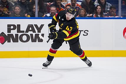 Nov 6, 2023; Vancouver, British Columbia, CAN; Vancouver Canucks defenseman Quinn Hughes (43) shoots against the Edmonton Oilers in the third period at Rogers Arena. Mandatory Credit: Bob Frid-USA TODAY Sports