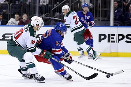 Nov 9, 2023; New York, New York, USA; New York Rangers defenseman Ryan Lindgren (55) fights for the puck against Minnesota Wild center Vinni Lettieri (10) during the second period at Madison Square Garden. Mandatory Credit: Brad Penner-USA TODAY Sports