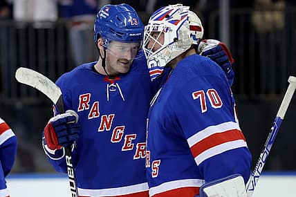Nov 9, 2023; New York, New York, USA; New York Rangers left wing Alexis Lafreniere (13) celebrates with goaltender Louis Domingue (70) after defeating the Minnesota Wild at Madison Square Garden. Mandatory Credit: Brad Penner-USA TODAY Sports