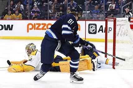 Nov 9, 2023; Winnipeg, Manitoba, CAN; Winnipeg Jets left wing Kyle Connor (81) scores on Nashville Predators goaltender Juuse Saros (74) in the second period at Canada Life Centre. Mandatory Credit: James Carey Lauder-USA TODAY Sports