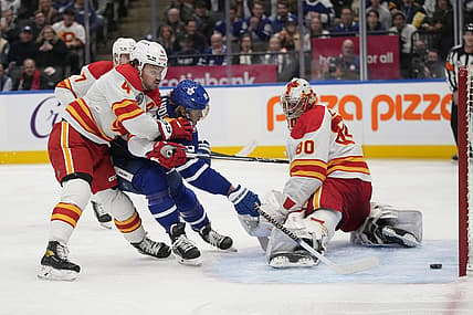 Nov 10, 2023; Toronto, Ontario, CAN; Toronto Maple Leafs forward William Nylander (88) scores against Calgary Flames goaltender Dan Vladar (80) and defenseman Rasmus Andersson (4) during the first period at Scotiabank Arena. Mandatory Credit: John E. Sokolowski-USA TODAY Sports