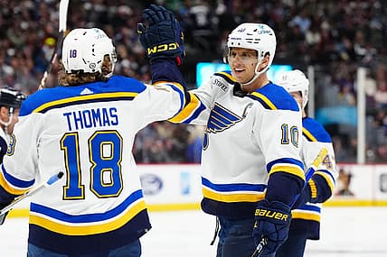 Nov 11, 2023; Denver, Colorado, USA; St. Louis Blues center Brayden Schenn (10) celebrates his hat trick goal with center Robert Thomas (18) in the third period against the Colorado Avalanche at Ball Arena. Mandatory Credit: Ron Chenoy-USA TODAY Sports