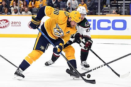 Nov 11, 2023; Nashville, Tennessee, USA; Nashville Predators center Ryan O'Reilly (90) handles the puck during the first period against the Arizona Coyotes at Bridgestone Arena. Mandatory Credit: Christopher Hanewinckel-USA TODAY Sports