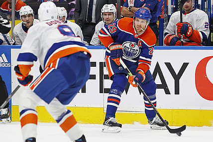 Nov 13, 2023; Edmonton, Alberta, CAN; Edmonton Oilers forward Leon Draisaitl (29) looks to make a pass in front of New York Islanders defensemen Noah Dobson (8) during the first period at Rogers Place. Mandatory Credit: Perry Nelson-USA TODAY Sports