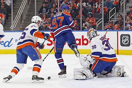 Nov 13, 2023; Edmonton, Alberta, CAN;  Edmonton Oilers forward Connor McDavid (97) tries to deflect a shot past New York Islanders goaltender Ilya Sorokin (30) during the first periodat Rogers Place. Mandatory Credit: Perry Nelson-USA TODAY Sports