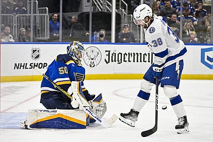 Nov 14, 2023; St. Louis, Missouri, USA;  St. Louis Blues goaltender Jordan Binnington (50) defends the net against Tampa Bay Lightning left wing Brandon Hagel (38) during the third period at Enterprise Center. Mandatory Credit: Jeff Curry-USA TODAY Sports