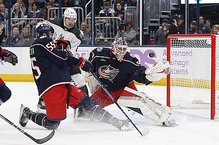 Nov 16, 2023; Columbus, Ohio, USA; Columbus Blue Jackets goalie Elvis Merzlikins (90) deflects the puck over the net as Arizona Coyotes left wing Matias Maccelli (63) awaits a rebound during the first period at Nationwide Arena. Mandatory Credit: Russell LaBounty-USA TODAY Sports