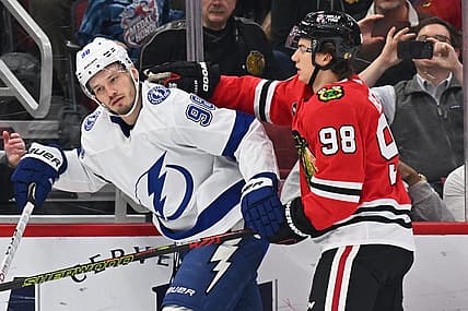 Nov 16, 2023; Chicago, Illinois, USA; Chicago Blackhawks forward Connor Bedard (98) pushes Tampa Bay Lightning defenseman Mikhail Sergachev (98) after Sergachev boarded Chicago Blackhawks forward Philipp Kurashev (23) in the first period at United Center. Mandatory Credit: Jamie Sabau-USA TODAY Sports