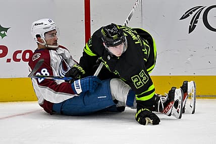 Nov 18, 2023; Dallas, Texas, USA; Dallas Stars defenseman Esa Lindell (23) checks Colorado Avalanche left wing Miles Wood (28) during the second period at the American Airlines Center. Mandatory Credit: Jerome Miron-USA TODAY Sports