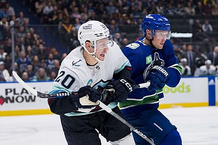 Nov 18, 2023; Vancouver, British Columbia, CAN; Seattle Kraken forward Eeli Tolvanen (20) battles with Vancouver Canucks forward Sam Lafferty (18) in the third period at Rogers Arena. Seattle won 4-3. Mandatory Credit: Bob Frid-USA TODAY Sports